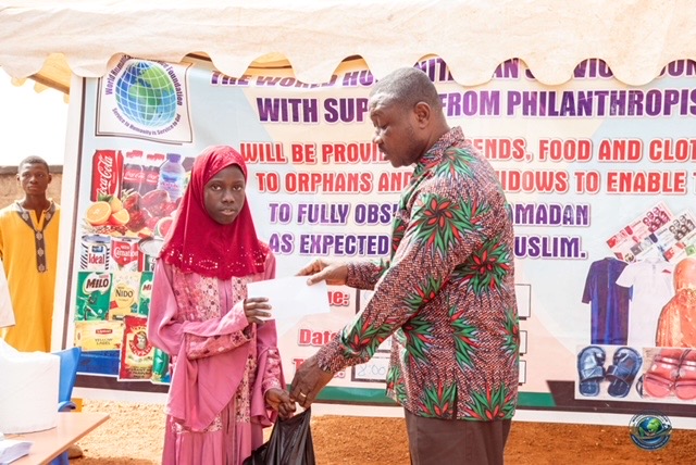 Young girl receiving stipend during the Ramadan distribution