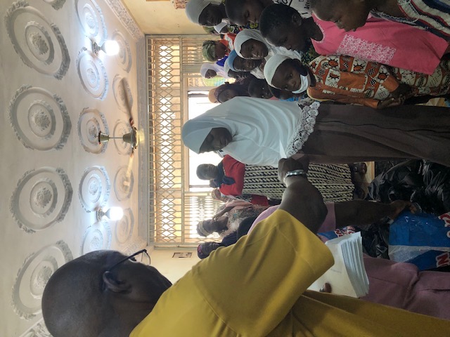 WHSF coordinator distributing supplies indoors to women and children